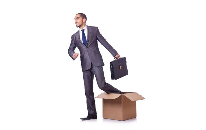 man climbing out of box